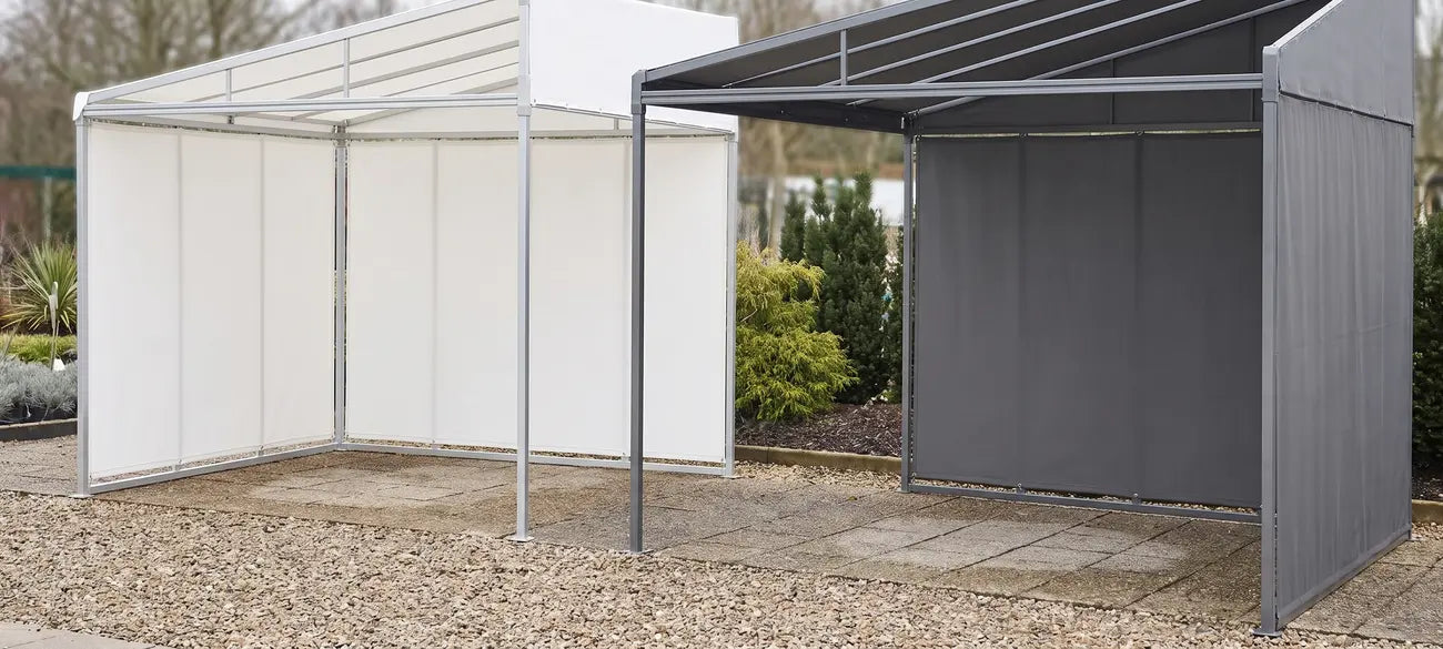 Patio cover structures fitted with white and anthracite grey fabric sidewalls